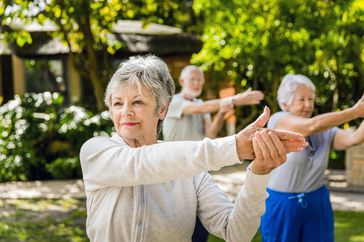 older adult reliving arthritis pain with gentle stretching