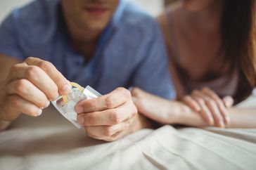 couple using condom to prevent hiv