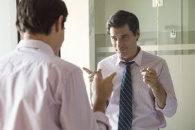 person with a superiority complex looking arrogant in the mirror