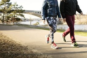 elderly woman and man walking outside