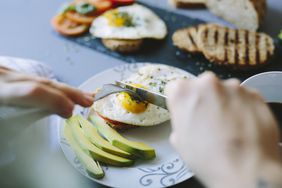 person eating eggs and avocado