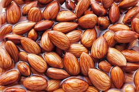 close up image of almonds soaking in water