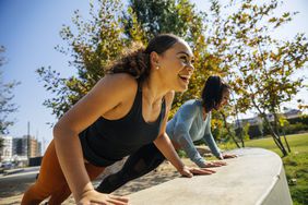 Women doing bodyweight exercises at a park