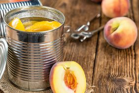 Canned peaches on a wooden table