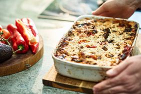 Close up image of vegan bake in oven dish next to fresh peppers