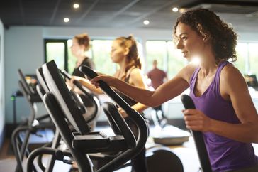 A woman in an elliptical machine at the gym