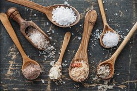Different salts on wooden spoons