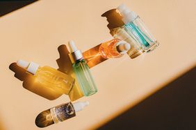 Assorted glass bottles with cosmetic liquids, serum or gel
