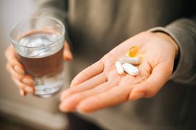 A hand holding a bunch of magnesium chloride pills in an open palm