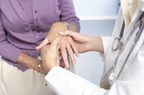 Doctor checking a woman's hand