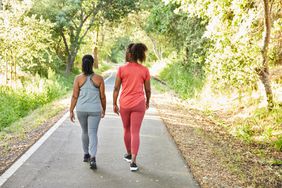 two women walking on nature trail