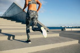 Woman sprinting up stairs during workout outdoors