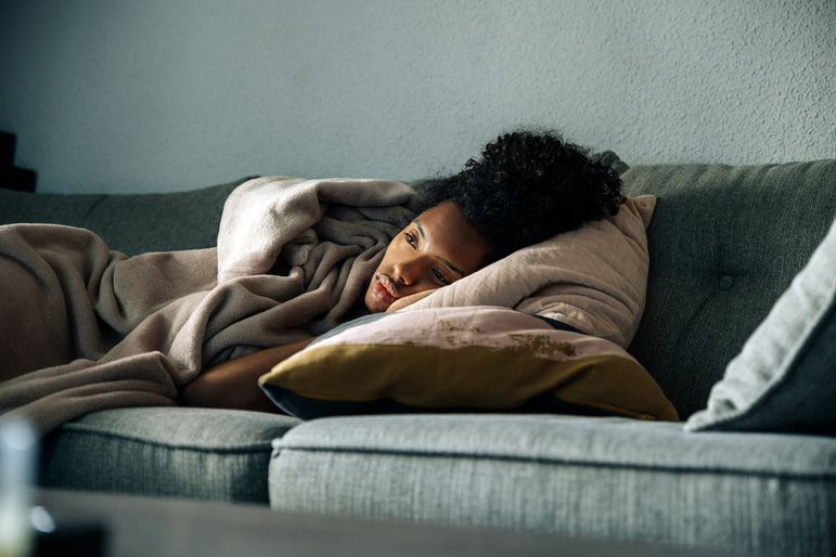 Depressed woman lying on the couch