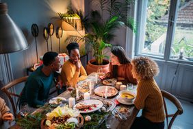 Group of friends celebrating Christmas together, toasting, having a great time