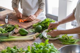 Series of lessons in a kitchen school where the chef teaching some contemporary food recipes. Women preparing vegetables cutting using knife. Only hands are visible.