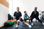 Two women with a trainer at the gym