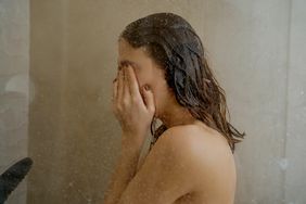  a woman relaxing in the shower