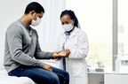 female doctor checking patient's pulse