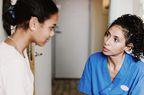 Female doctor discussing with patient in medical room at hospital