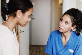 Female doctor discussing with patient in medical room at hospital