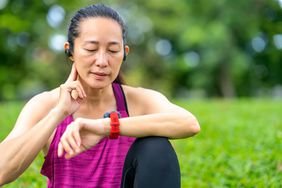 person measuring pulse while working out