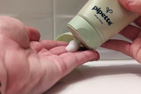 Hand squeezing Pipette eczema lotion onto fingertips