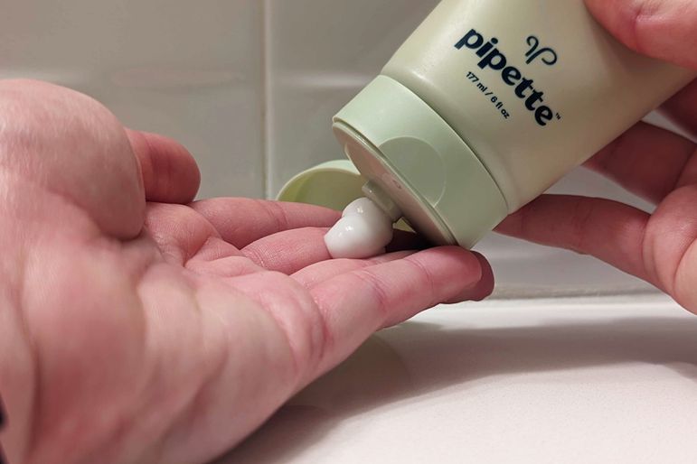 Hand squeezing Pipette eczema lotion onto fingertips