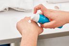 Hand pumping Neutrogena Hydro Boost Hyaluronic Acid Moisturizer on the back of the other hand