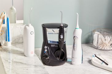 A selection of water flossers displayed on a bathroom counter