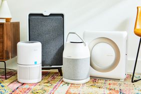 4 air purifiers on a carpet