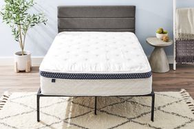 The Winkbed Mattress on a bed frame in a bedroom.