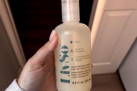 A person holds up a bottle of LivSo Moisturizing Shampoo