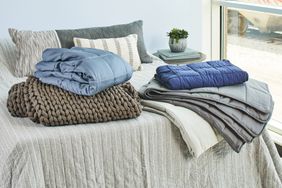 A selection of weighted blankets on a bed.