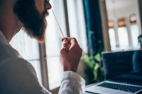 man taking home covid test