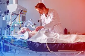 Intensive care caucasian doctor examines intubated critical condition
