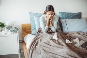 person sick in bed with influenza b symptoms