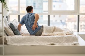 man with kidney stone experiencing back pain 