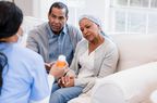 doctor showing couple with cancer patient a medication 