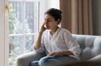 woman with lupus with fever and fatigue sitting on couch 