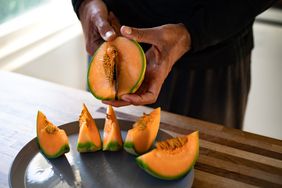 A man slicing a cantaloupe, Japanese melon