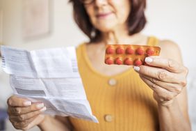 person experiencing menopause taking medication to treat symptoms