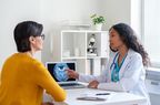 doctor showing older woman patient brain scan 