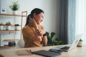 woman scratching her neck and arm