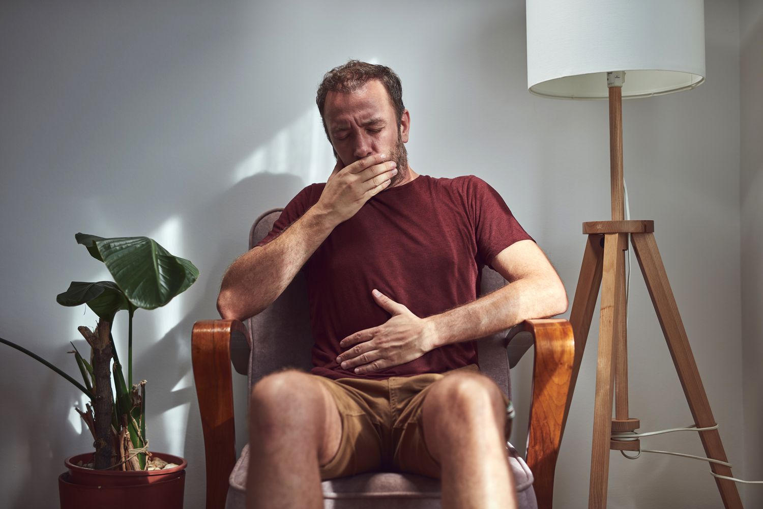 person with peptic ulcer disease experiencing burping and abdominal pain