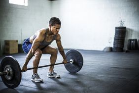 A woman doing a deadlift in a gym