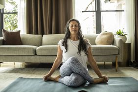 woman doing yoga and breathing exercises on the floor 