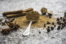The ingredients for a pumpkin spice mix, arranged separately and blended in a still life display.