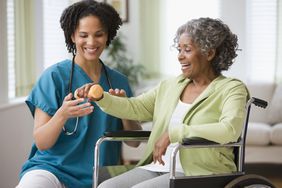 older woman getting physical therapy treatment for rheumatoid arthritis
