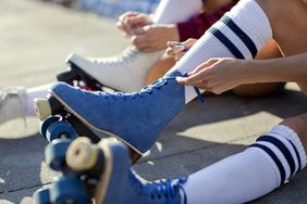 close up of rollerskates being laced up