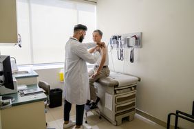 senior man receiving flu shot